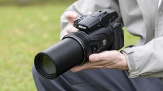 Nikon Coolpix P1100 superzoom camera in the hand