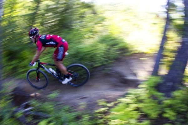 A BMC riders flies past