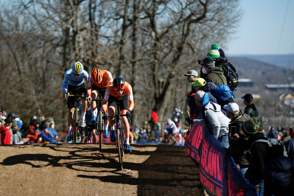 FAYETTEVILLE ARKANSAS JANUARY 29 LR Emiel Verstrynge of Belgium Mees Hendrikx of Netherlands and Pim Ronhaar of Netherlands compete while fans cheer during the 73rd UCI CycloCross World Championships Fayetteville 2022 Mens U23 Fayetteville2022 on January 29 2022 in Fayetteville Arkansas Photo by Chris GraythenGetty Images