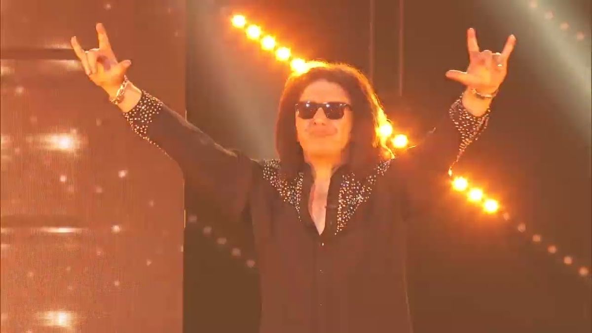 Gene Simmons throwing the horns onstage in 2024