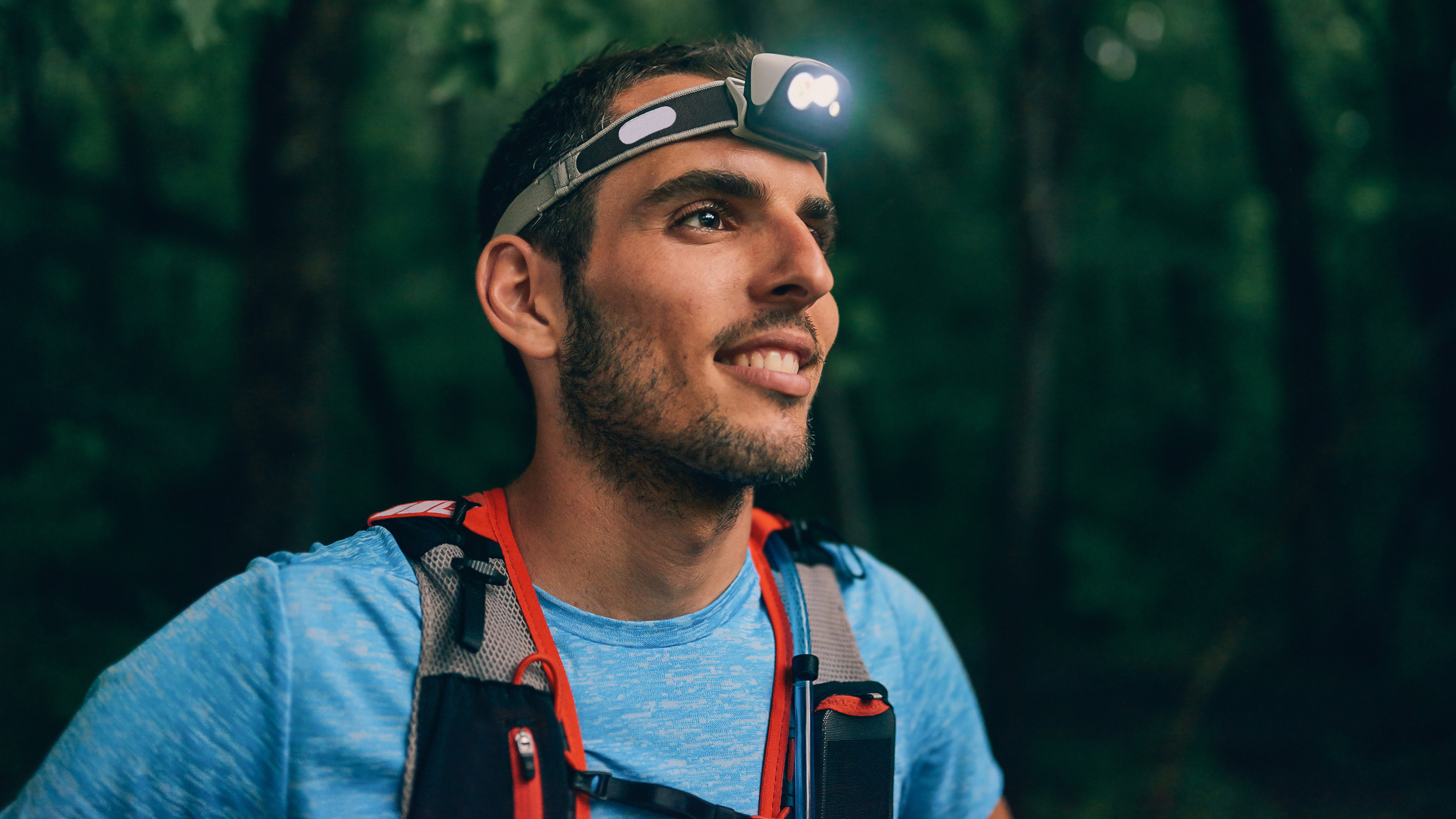a male runner wearing a headtorch