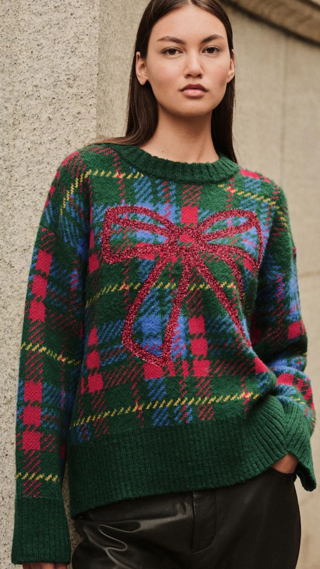 a model wearing a tartan christmas jumper