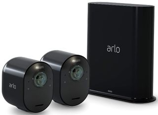 A pair of Arlo ultra pet cameras sit next to the base.