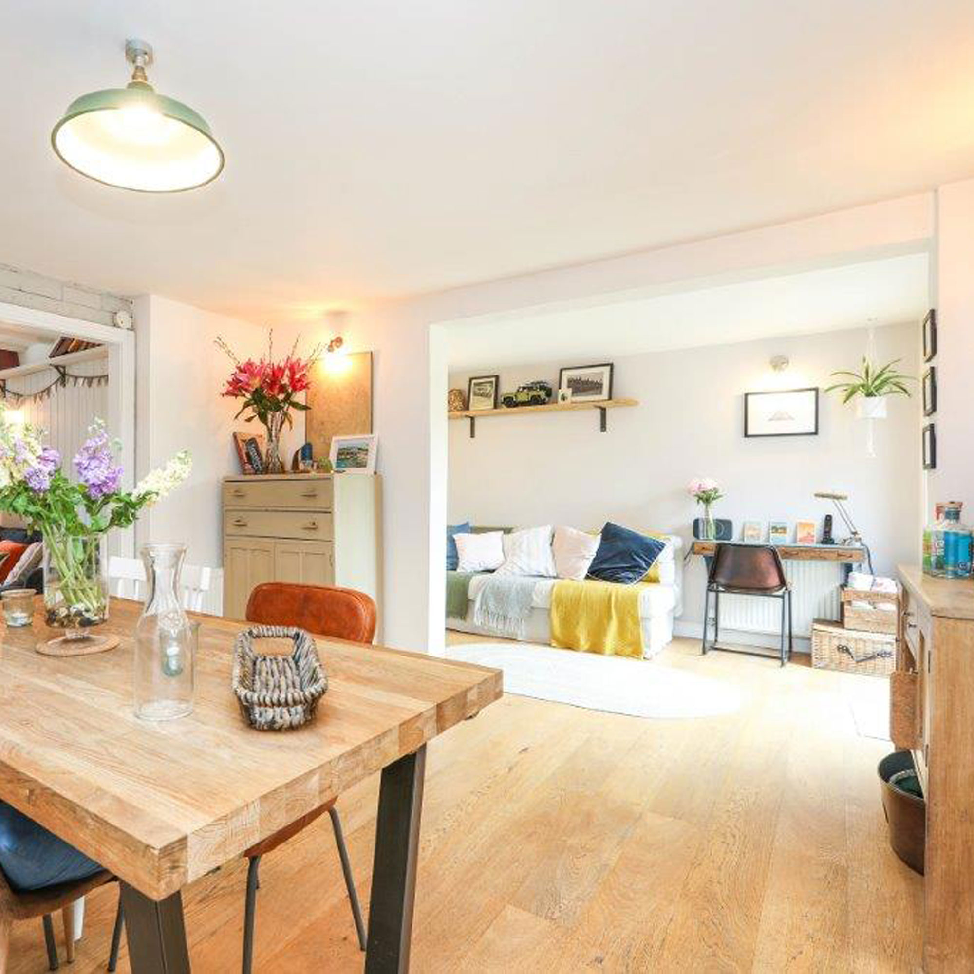 dining room with wooden flooring and snug beyond