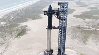 SpaceX stacks its Flight 4 Starship vehicle on the orbital launch mount at its Starbase site in South Texas. This is a still from a video SpaceX posted to X on May 15, 2024.