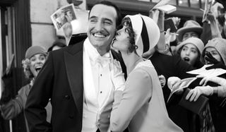 The Artist Jean Dujardin is kissed by Berenice Bejo in front of a crowd of fans