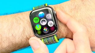 Close-up of the Apple Watch 11 on a user's wrist with the digital crown being pressed to reveal the new Dynamic App Grid
