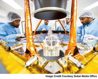 Engineers at the UAE Space Agency's Mohammed bin Rashid Space Centre discuss work on a sun shield for the Hope Mars probe, a robotic spacecraft to launch toward Mars by 2021.
