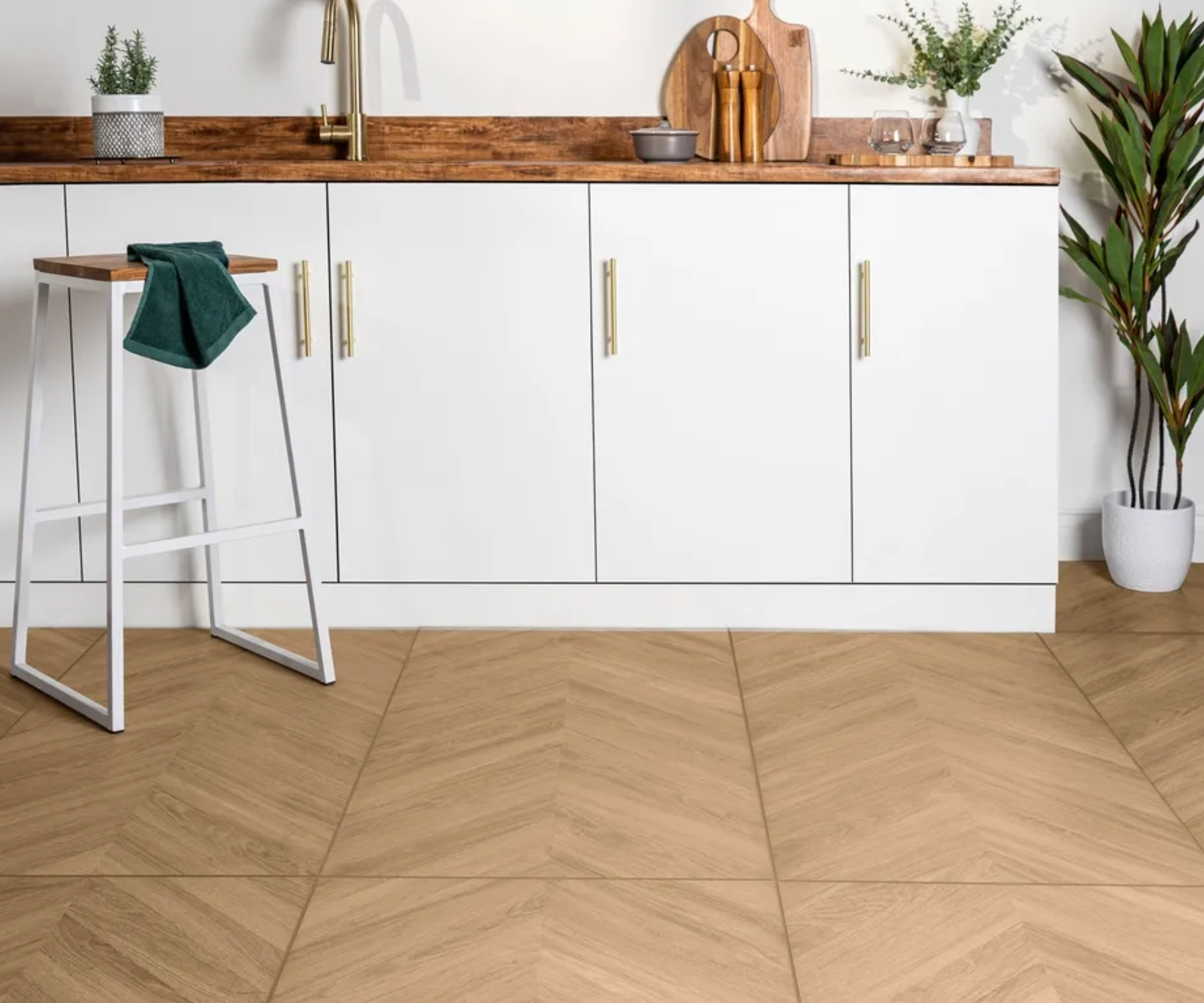 modern white kitchen with herringbone porcelain floor tiles
