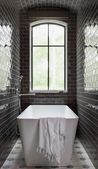 Bathroom tiled in grey subway tile