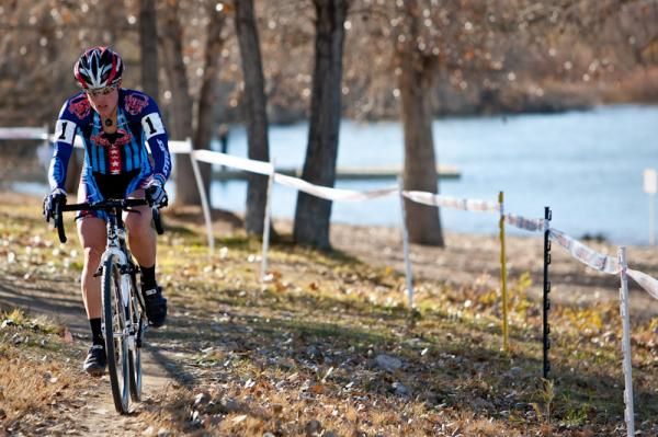 Katie Compton (Planet Bike) rides solo through the fall leaves.