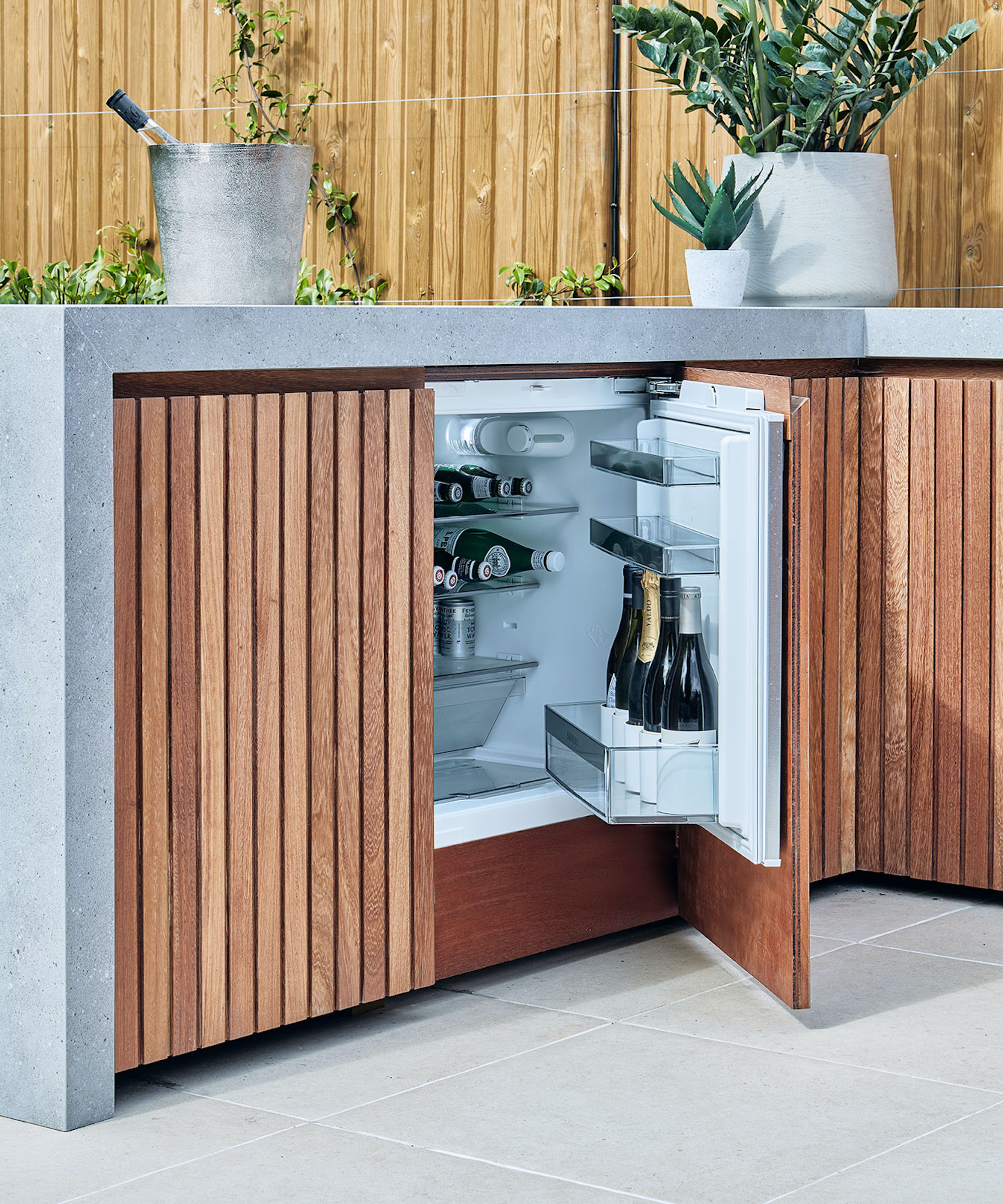 outdoor kitchen with fridge and open door