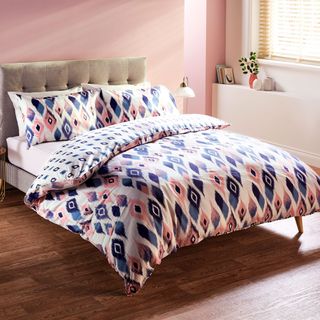pink and blue aldi bedding set with wooden flooring