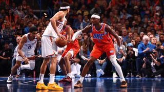 Shai Gilgeous-Alexander defending against Devin Booker in a Suns vs Thunder game