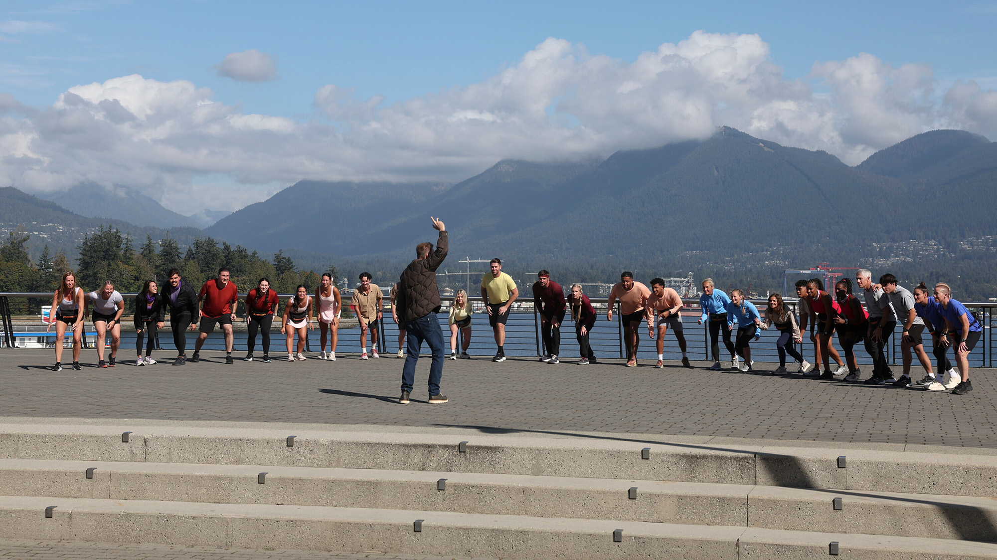 Phil counts down the start of a leg in front of a bunch of teams on The Amazing Race Season 39.