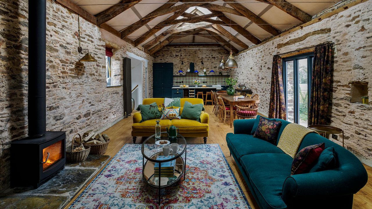 living room with yellow sofa arched roof wooden table and chair