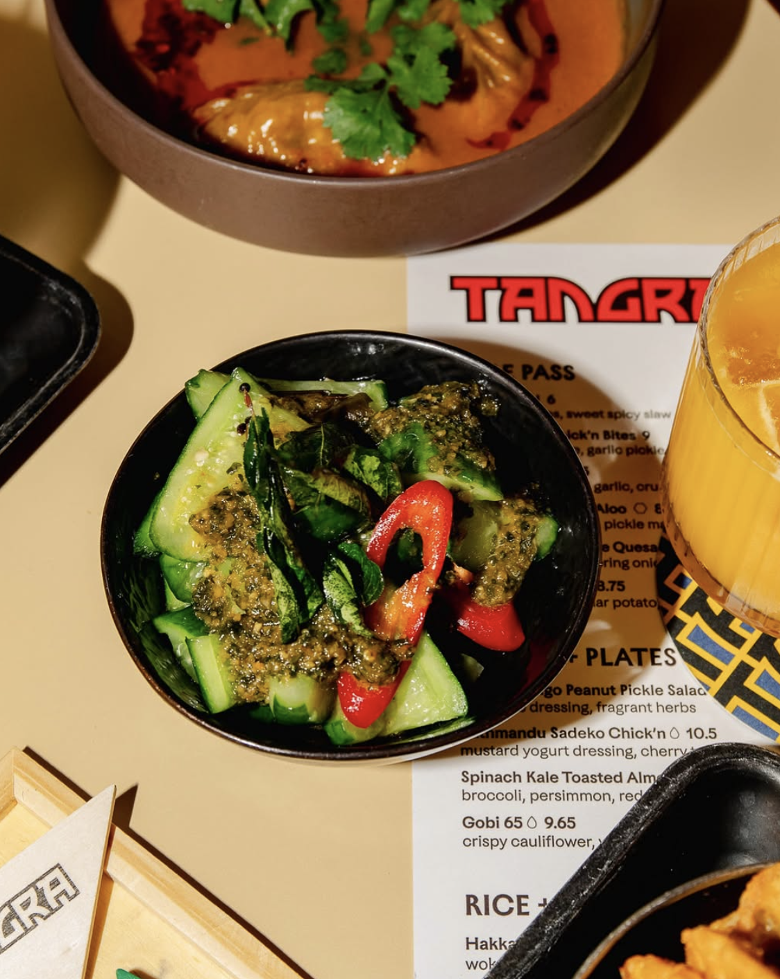 an image of a cucumber starter dish on a table of food at Tangra