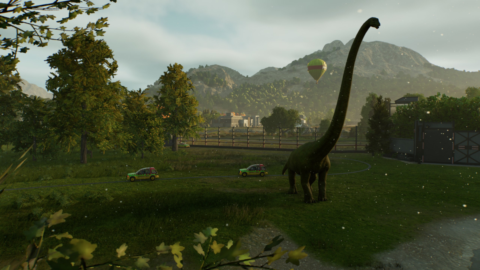 The tour mode lingers on a majestic Diplodocus in Jurassic World Evolution 3 as cars drive by, a balloon in the background