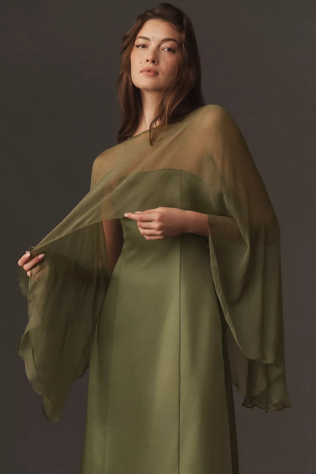 A green sheer cape on a model