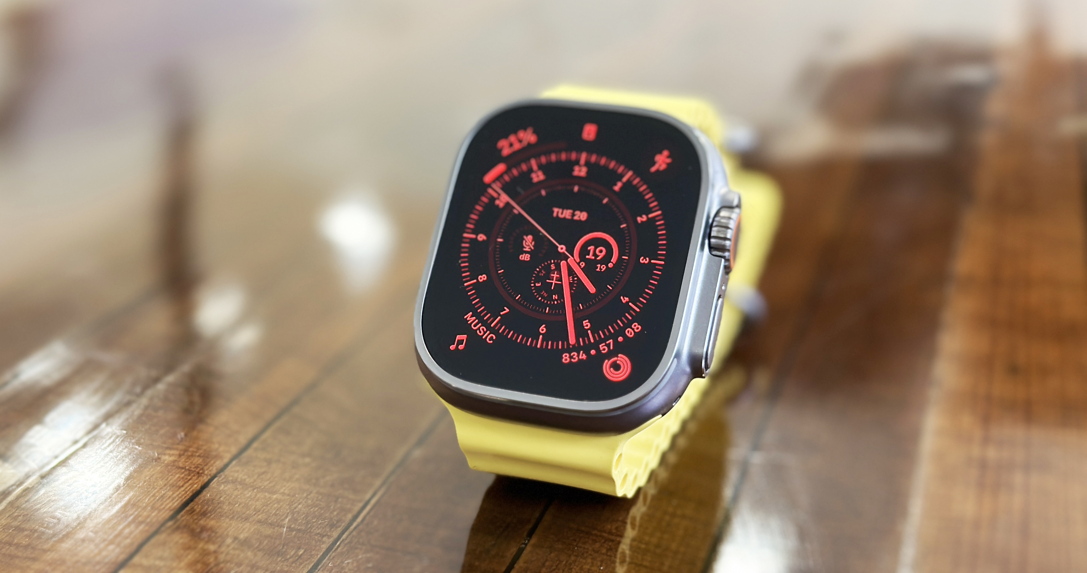 Apple Watch Ultra in use on wrist and on table