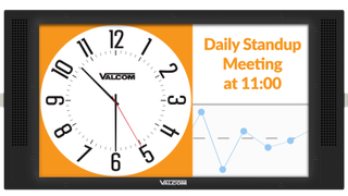 An image of a clock announcing a meeting on a touchpanel display. 