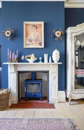 Blue living room with white marble fireplace