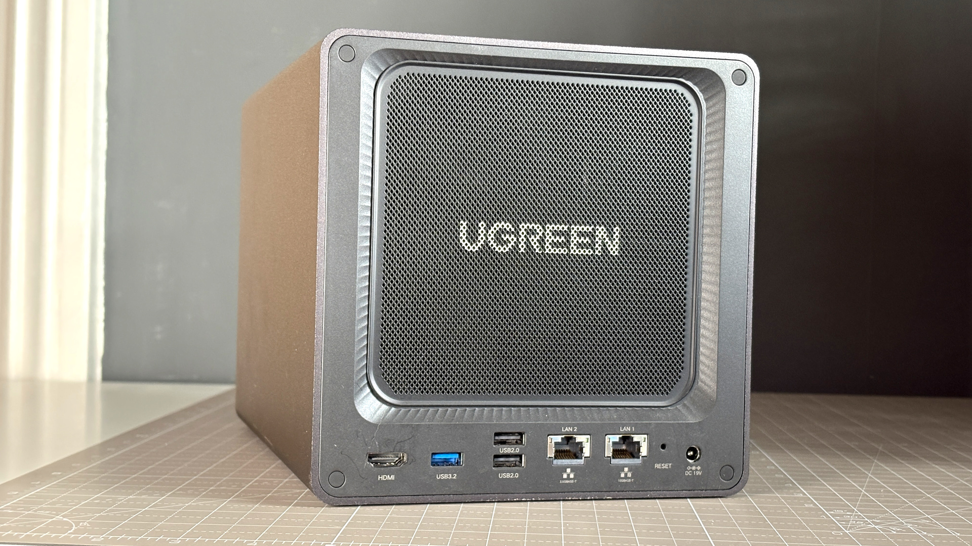 UGreen NASync DXP4800 Pro on a desk with multiple HDDs installed.