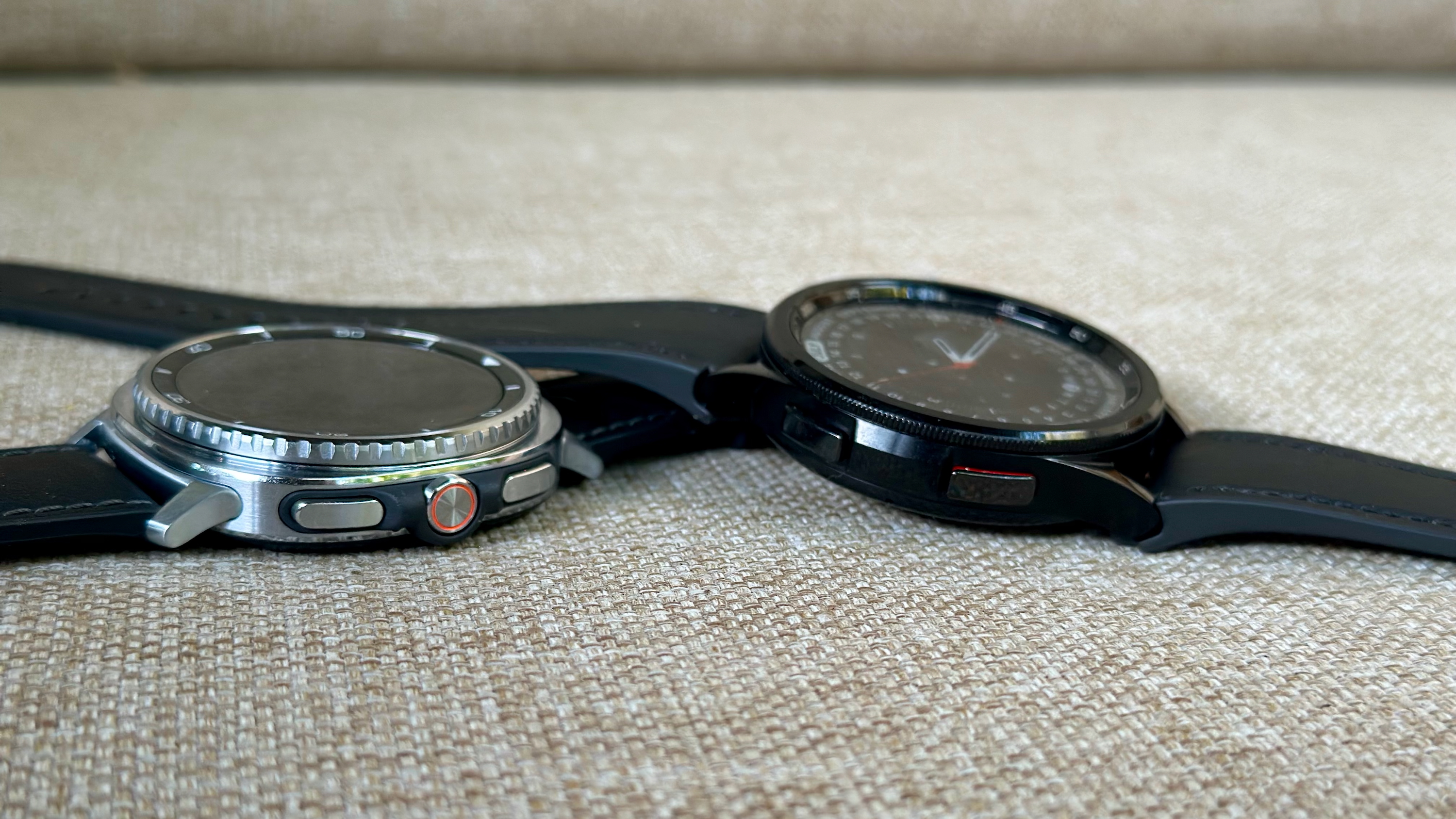 The Samsung Galaxy Watch 8 Classic (left) and Samsung Galaxy Watch 6 Classic (right) aside each other, the 8's three buttons and 6's two buttons facing forward. 