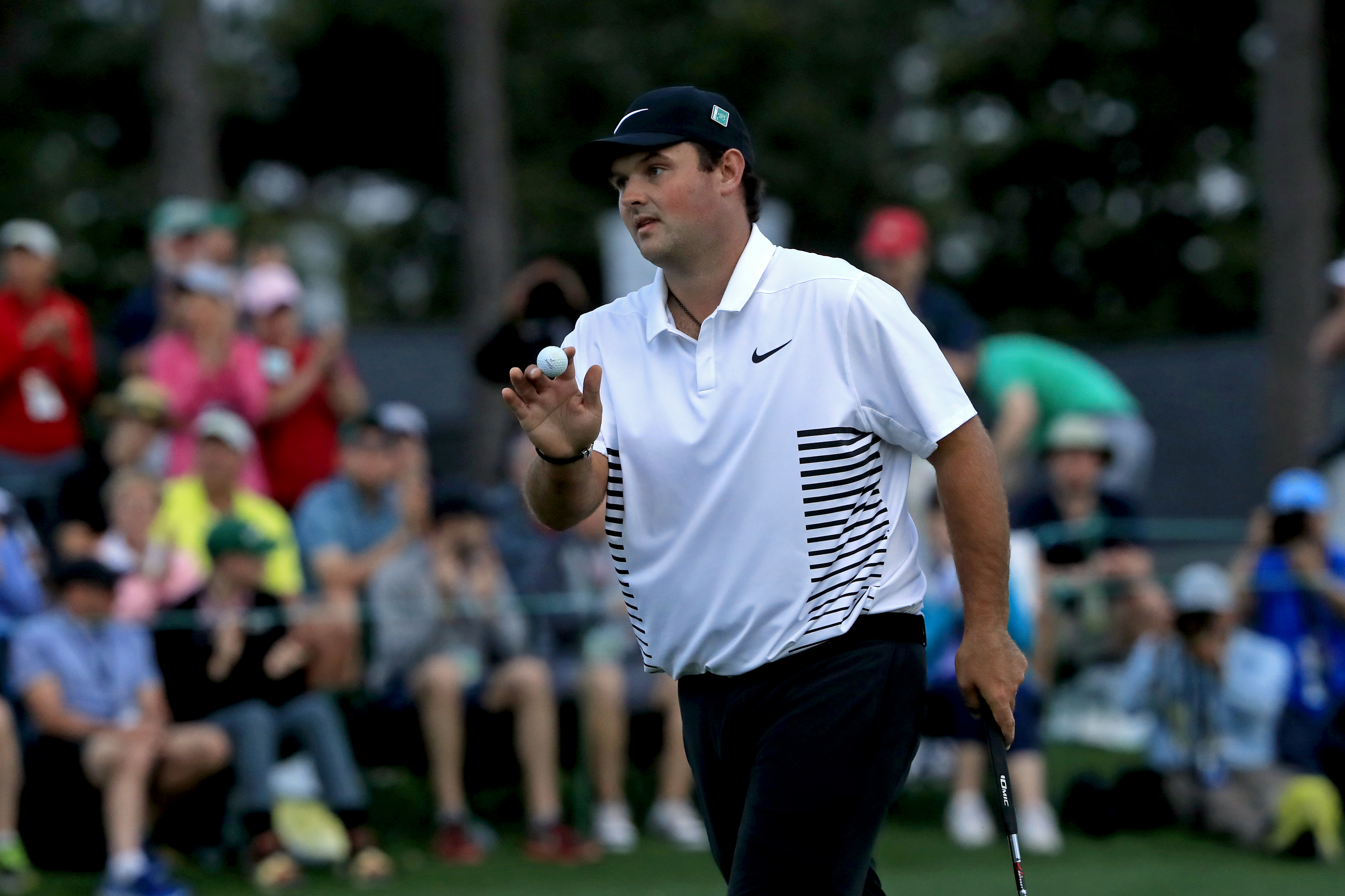 Patrick Reed waves to the crowd during the 2018 Masters