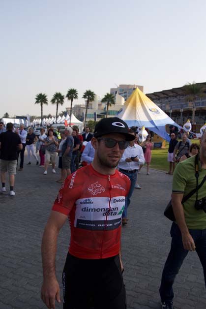 Mark Cavendish arrives for stage two in the red jersey