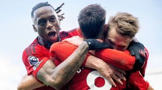 Scott McTominay and Aaron Wan-Bissaka celebrate with Bruno Fernandes after the Portuguese's late winner for Manchester United against Fulham in November 2023.