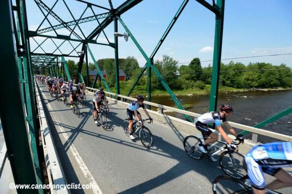 The Tour de Beauce peloton crosses a bridge