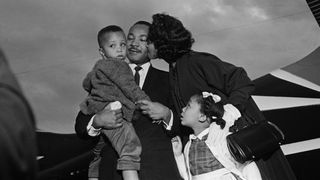 Dr. Martin Luther King, Jr. embraces his wife Coretta and children, Marty and Yoki after he is freed from jail under a $2000 appeal bond at the airport in Chamblee, Georgia.