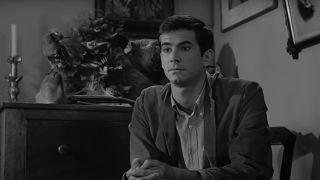 Anthony Perkins sits in conversation with taxidermy on display in Psycho.