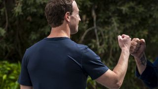 Mark Zuckerberg fist bumping someone