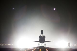 Xenon lights help lead space shuttle Endeavour home to NASA's Kennedy Space Center in Florida.