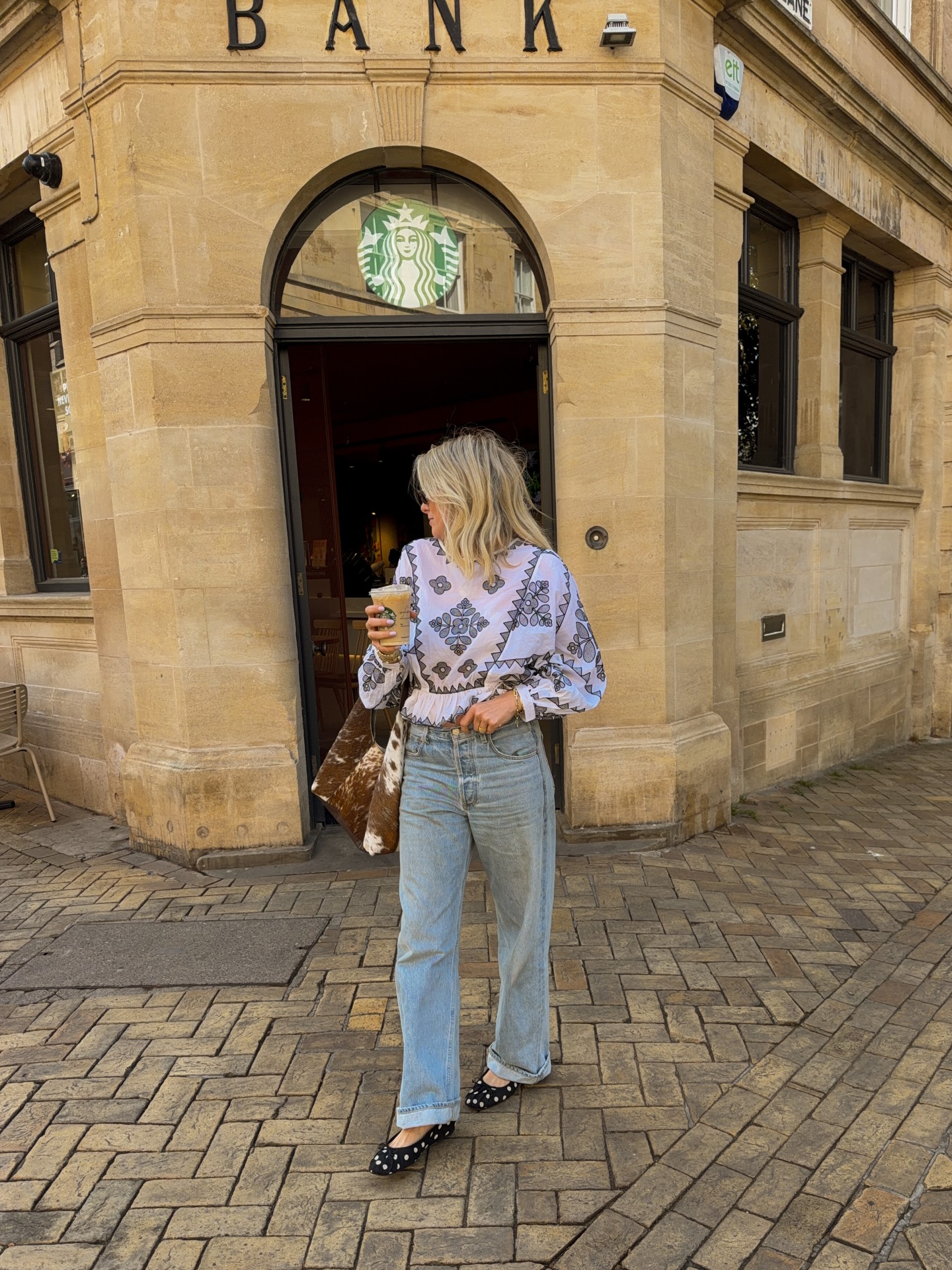 A woman wearing fall 2026 cuffed-jeans outfit idea.