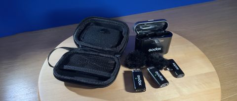 Godox WES2 Microphone and case on a wooden table