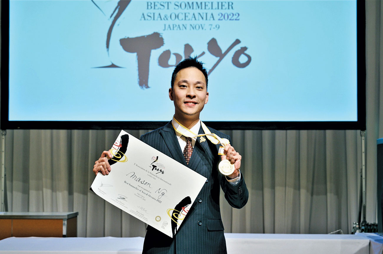 Mason Ng with certificate for winning ASI Best Sommelier of Asia &amp; Oceania 2022, plus award logo on screen in background