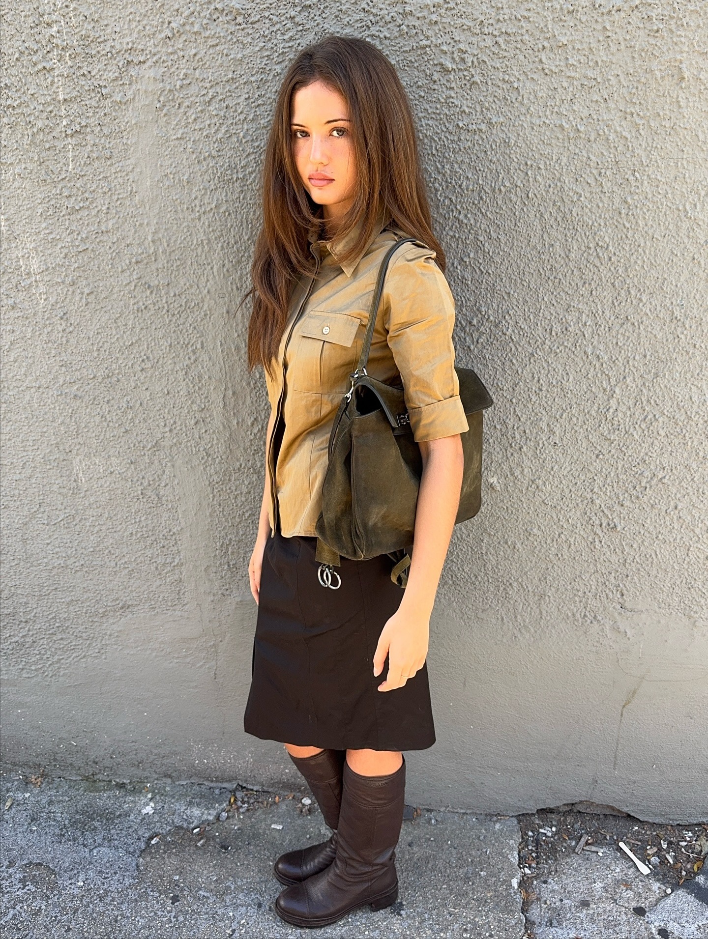 @rubylyn_ wearing a chic spring boot and skirt outfit