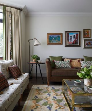 An Arts & Crafts style living room with white walls and earthy colors introduced through decor and upholstery