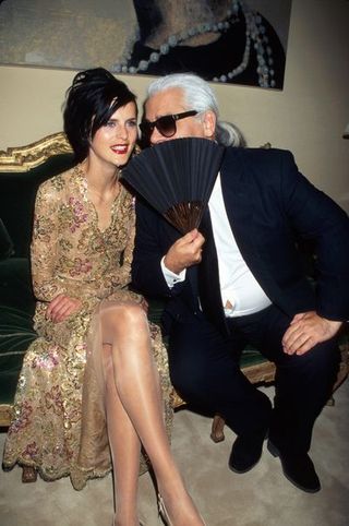 model stella tenant and fashion designer karl lagerfeld face partially obsc by fan at chanel store opening photo by dave alloccadmithe life picture collection via getty images