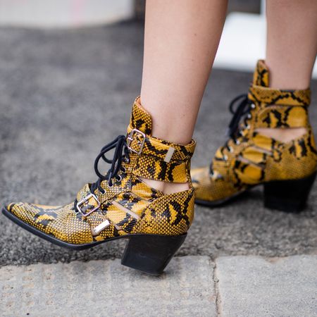 woman wearing yellow snakeskin summer boots