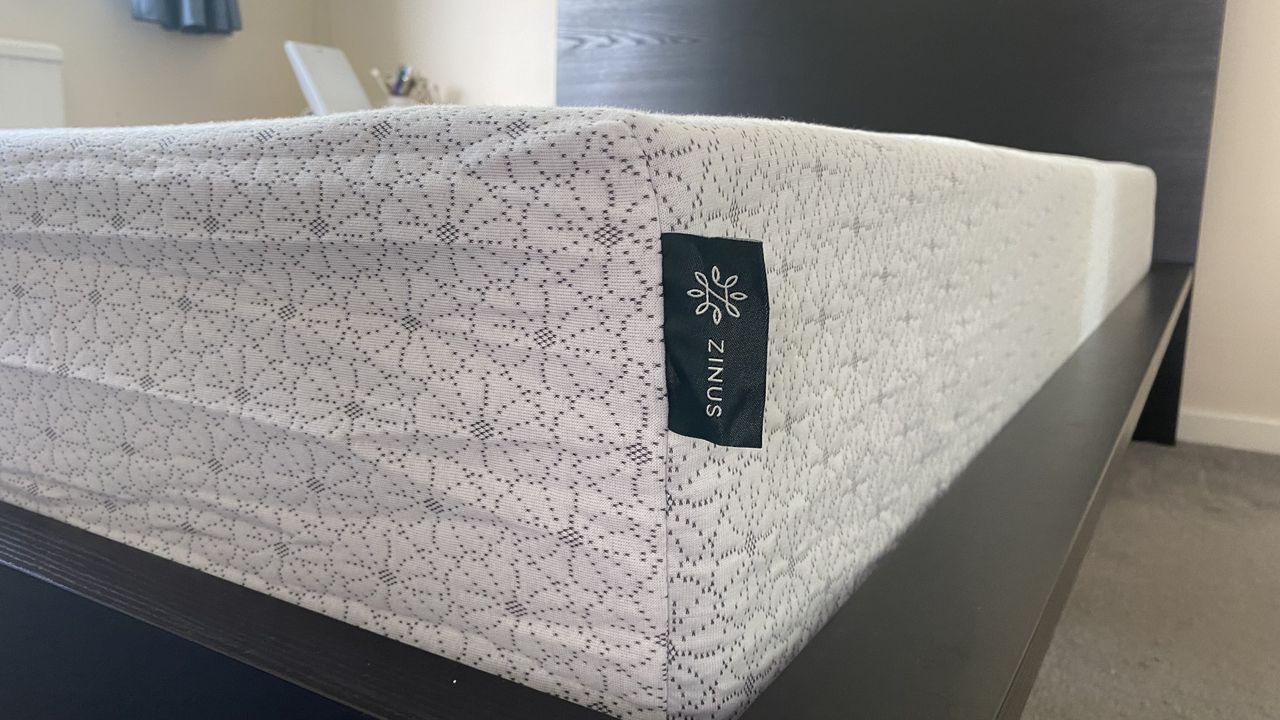 A closeup of the Zinus Green Tea Memory Foam Mattress showing the Zinus label