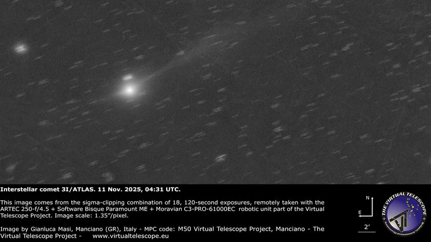 A bright, fuzzy point of light representing a comet&#039;s central coma is visible shining to the lower left of an image, with a faint tail extending to the upper left lof the screen. Points of light representing stars are visible in the black sky beyond.