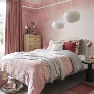 bedroom with peach wall and double bed