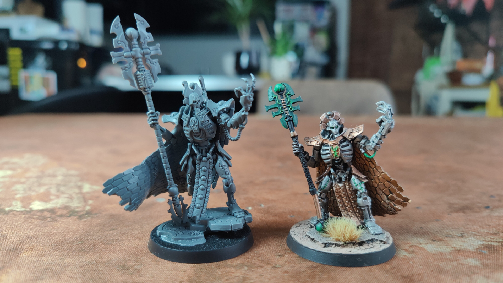 New Imotekh the Stormlord model alongside the old version, both on a wasteland battlemat