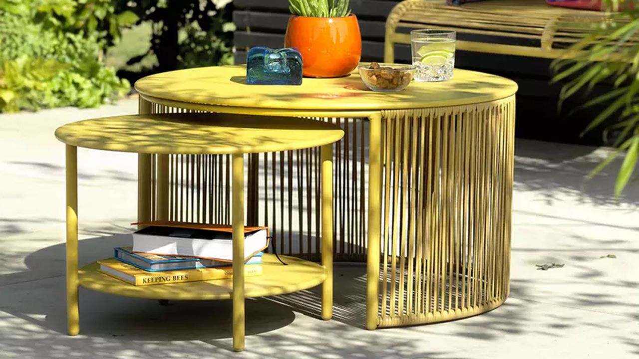 Yellow Ipanema metal garden nesting coffee tables in bright and sunny patio space