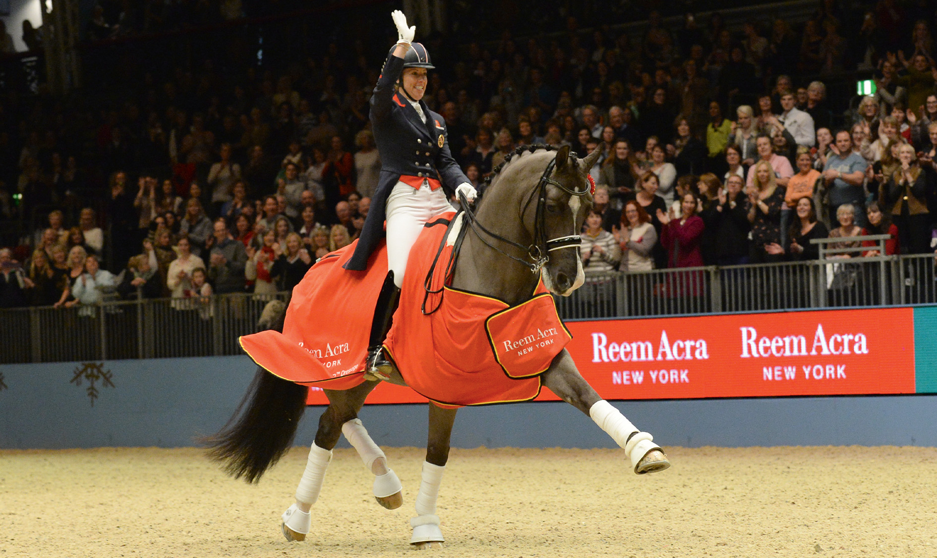 Charlotte Dujardin celebrates after breaking the world record on Valegro at Olympia in 2014