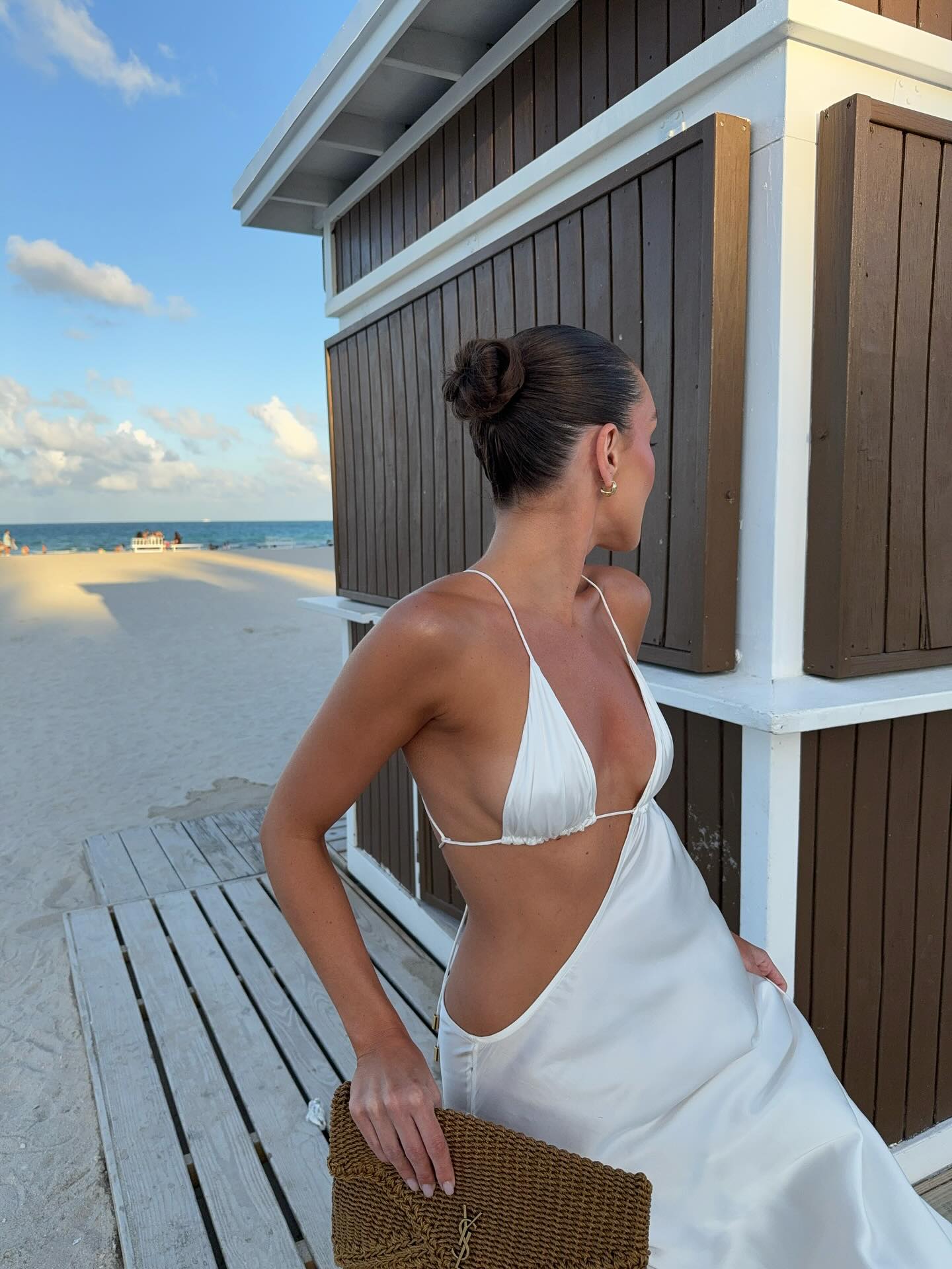 Photo of a woman wearing a slick-back bun on the beach